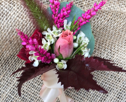 bright corsage on burlap