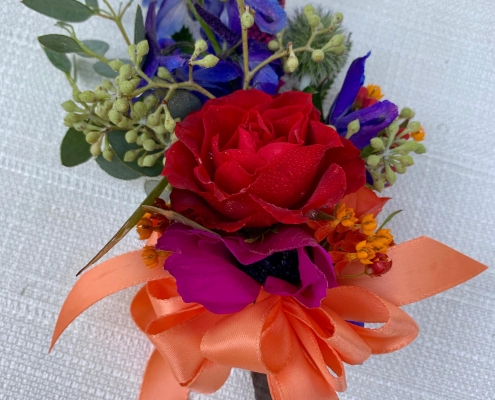 corsage with peach ribbon